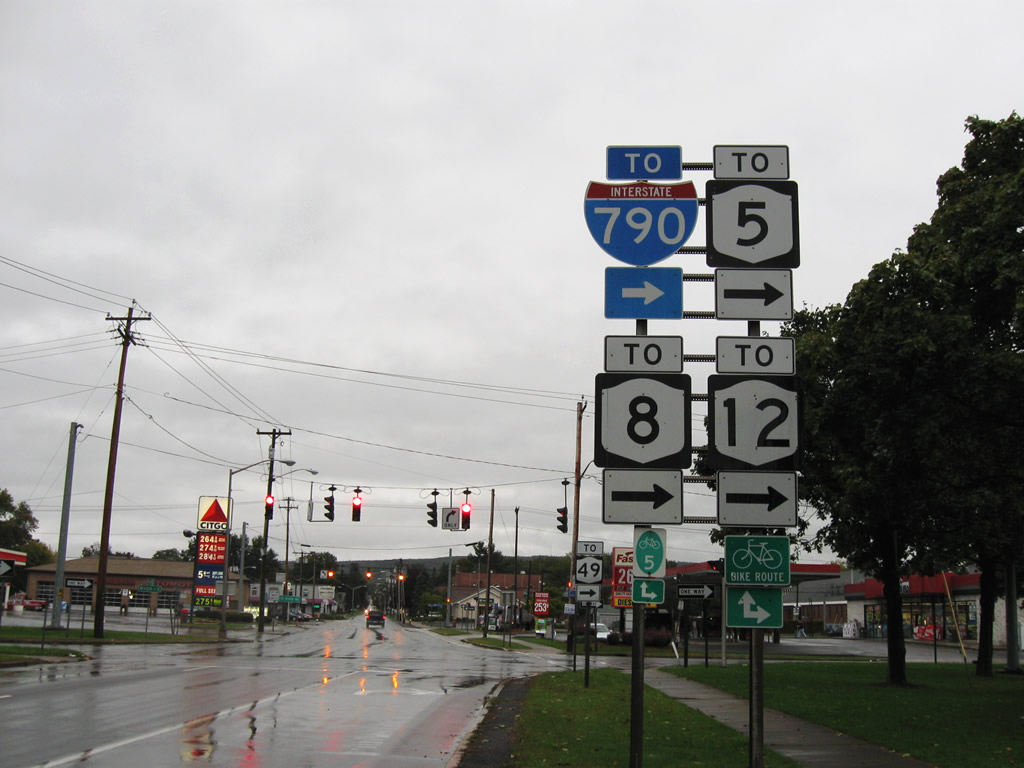 Trailblazer directing motorists to make a right turn onto Auert Avenue to reach westbound Interstate 790 and New York 5. New York 8 and New York 12 intersect the 2.7 mile long interstate at an interchange one mile to the west.