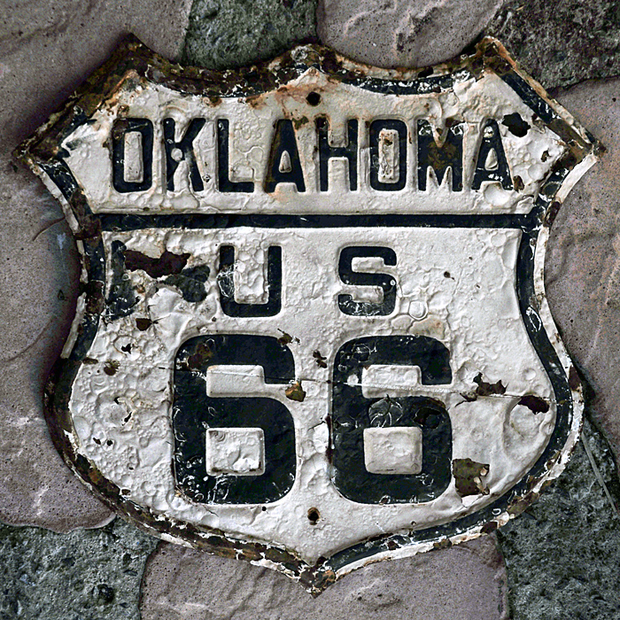 A genuine sign. Reflective sheeting was likely retrofitted to a previously done route marker.
