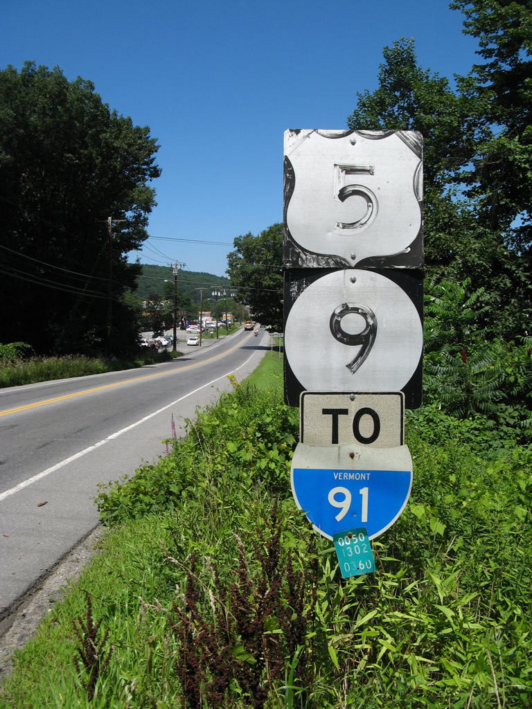 Northbound U.S. 5 in Brattleboro; note old specs for all three shields as well as the milepost for U.S. 5 at the bottom of the shield assembly.