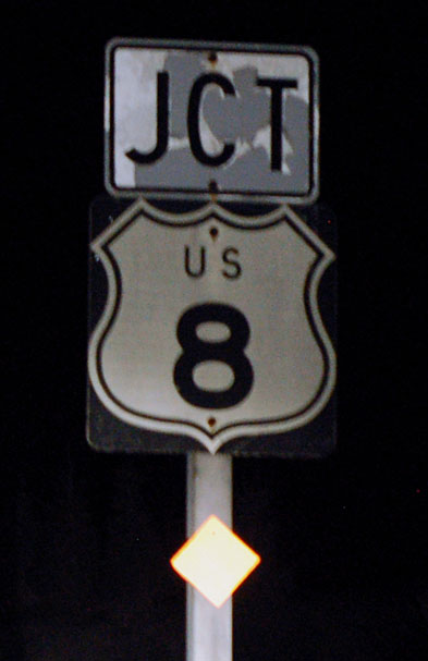 This sign is on aluminum.  Wisconsin alternated between wood and aluminum several times after abandoning embossed steel shields during World War II.