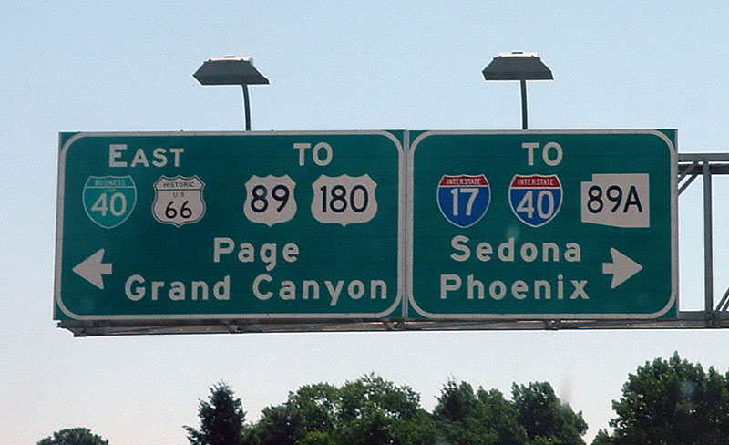 Arizona - business loop 40, U.S. Highway 89, U.S. Highway 180, Interstate 40, Interstate 17, U.S. Highway 66, and state highway 89A sign.