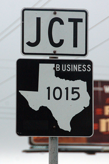 Texas business farm to market road 1015 sign.