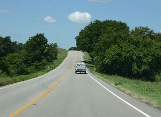 Northwest of US 281, SH 6 resumes as a two lane highway.