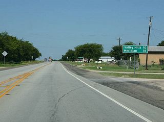 Mileage sign to Valley Mills and Meridian, as SH 6 returns to a two lane alignment.