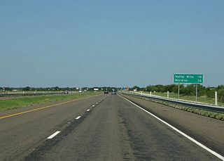 Mileage sign to Valley Mills and Meridian.