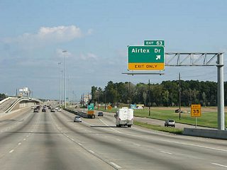 Exit 63 joins the North Freeway Service Road as IH 45 leaves the Houston city limits. Airtex Drive is an arterial serving nearby industrial parks and residential areas east to the Hardy Toll Road.