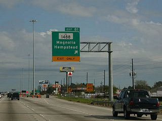 Exit 81 departs IH 45 north in south Conroe ahead of a cloverleaf interchange joining the North Freeway frontage roads with FM 1488.