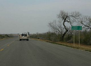 Distance sign to the towns of Pawnee and Kenedy.