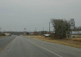 Kenedy is the second-largest town along SH 72, a railroad junction named after the original anglo owner of the land. In the early 1900s, Kenedy was known for its gunfights that led to the nickname Six-Shooter Junction. Today, the town holds a Bluebonnet festival in April. SH 72 approaches SH 239 and US 181 here.