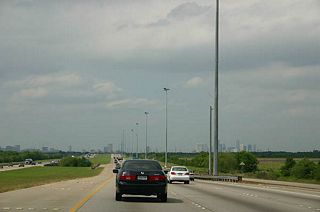 This is a typical profile of SH 288 with the wide median and no frontage roads. The south side of Houston is relatively undeveloped, as can be seen by the view of downtown from here.