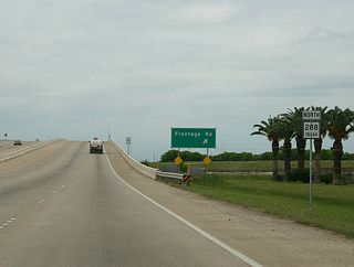 A slip ramp carries Texas 288 northbound travelers onto the Texas 332 frontage road system (Crescent Heights Street) around the three-quarter cloverleaf interchange between the two state highways.