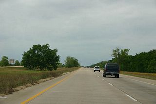 An undeveloped freeway like stretch of Texas 288 carries drivers northward toward Brazoria County Route Airport (LBX).