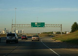 This sign is a relic of the original design. SH 288 featured inner express lanes and outer local lanes, similar to the design of U.S. 54 in El Paso. Only the outer local lanes were ever built due to funding problems. Today, the inner express lanes are under study as a possible toll road corridor.
