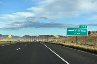 Desert Colors Parkway leads south from a folded diamond interchange (Exit 1) with SR 7 through expanding commercial and residential areas to the Arizona border. 