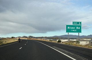 SR 7 west passes to the south of White Dome one mile out from a diamond interchange (Exit 3) with River Road.
