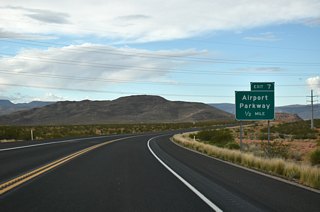 Located along the Arizona border, Little Black Mountain rises in the distance one half mile ahead of a diamond interchange with Airport Parkway.