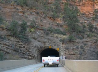 The Zion-Mount Carmel Tunnel was constructed in the 1920s. It was designed with no interior lights, occasional glimpses to the valley below through open vents, and a narrow width since it was meant to accommodate the small vehicles from that era.