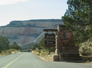 Upon entering Zion National Park, SR 9 changes into the Zion-Mount Carmel Highway. This entrance sign is the last chance to turn around before paying the park entry fee per vehicle.