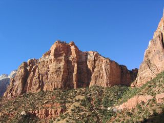 Continuing to the floor of the valley, Zion-Mount Carmel Highway passes by some magnificent vistas of the rock formations that line the surrounding mountains.
