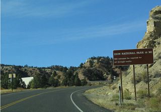Zion National Park requires a fee (per vehicle) for entry. It is a very expensive through route to St. George from Mount Carmel.
