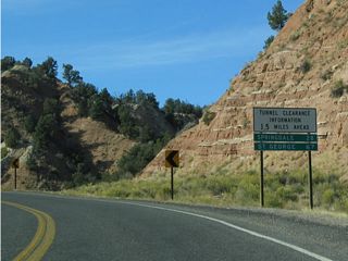 Mileage sign along westbound for Springdale and St. George. The east entrance, main visitors center, and various attractions in Zion National Park are omitted.