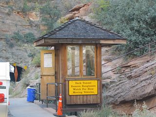 The warning sign on this guard station should be heeded. The tunnel interior is very dark, and it is over a mile in length. A bright sunny day contrasts poorly with the dark interior.