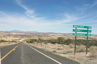 About ten miles northeast of Escalante, this mileage sign along Utah 12 east provides the distance to Boulder (18 miles) and the towns of Torrey and Teasdale via Utah 24 west (55 and 60 miles, respectively). Utah 12 ends at Utah 24 just west of Capitol Reef National Park near Torrey.