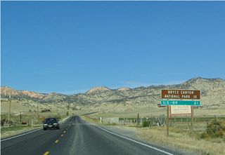 Mileage sign along westbound after leaving Cannonville. The two destinations listed on this sign are Bryce Canyon National Park via Utah 63 and U.S. 89. Rubys Inn (Utah 63) and Red Canyon is omitted.