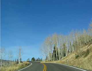 As Utah 14 ascends from Cedar City (elevation 5,800 feet) to Midway Summit (elevation 9,896 feet), it passes through some dramatic scenery including several tall cliffs, mountain terrain, and alpine forests. This area is part of the Dixie National Forest, which includes several discontinuous units in southern Utah.