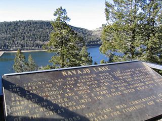 Signage for Navajo Lake along Utah 14. Navajo Lake drains into the Colorado River Basin, while nearby Duck Creek drains into the Sevier River drainage, which is part of the Great Basin. Utah 14 forms a divide of sorts, with drainage to the south generally flowing into the Virgin River and drainage to the north flowing into the Sevier River (with some exceptions closer to Long Valley Junction).