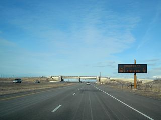 A variable message sign along Utah 67 (Legacy Parkway) provides travel times when not being used for emergency communication to motorists (in the event of traffic, weather, or other delays).