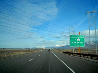 Towering power lines (including a couple of 345kV lines) cross over Utah 67 (Legacy Parkway). Exit 4 is about one-half mile north of here. Note the use of Clearview font on this and other guide signs on the Legacy Parkway. This was the first application of Clearview within the state of Utah.