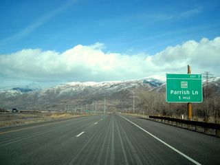 The next exit along Utah 67 (Legacy Parkway) north is Exit 7, Parrish Lane (one mile). A parallel set of 345kV power lines again come into view along northbound.