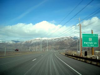 Northbound Utah 67 (Legacy Parkway) advances a half mile to Exit 7 for Parrish Lane. A 345kV power line was placed into service along this major power line corridor by 2011. This particular line was part of a long extension of 345kV north into Idaho on a course generally parallel to Interstate 15.