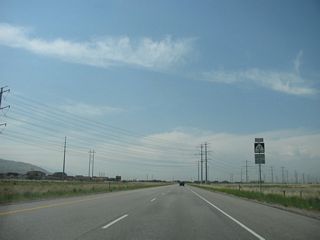 A Utah 67 (Legacy Parkway) shield is posted after the 500 South interchange. The 345kV power lines will again cross over Utah 67.