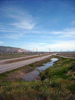 Looking south from 500 West, this view shows Utah 67 between the 500 South and Interstate 215 interchanges. As required by the permit to build the freeway, bioswales and wetlands line the route, including a noticeable one between the travel lanes and the southbound on-ramp.