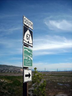 This Utah 67 route marker is posted along eastbound West 500 South, with a view looking south on the Legacy Parkway.
