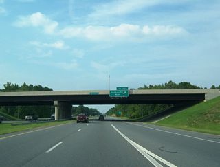 The loop ramp for Hanbury Road west at Exit 10A was added later. Hanbury Road heads west to Battlefield Boulevard and Johnstown Road in Great Bridge. Etheridge Manor Boulevard extends east  through suburban areas to Centerville Turnpike.
