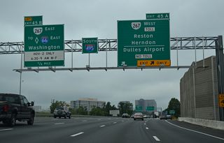 Two lanes part ways with I-495 south for SR 267 west at Exit 45. SR 267 stretches 28.5 miles west from I-66 near Falls Church to U.S. 15 at Leesburg. The extension from Dulles Airport to Loudon County opened in 1995 as the Dulles Greenway toll road.
Left Exit 45B leaves for SR 267 east to I-66 east. All lanes of I-66 operate as HOT Lanes during the inbound commutes hours (6:30-9 AM weekdays).