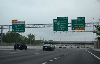 Southbound I-495 at the dual off-ramps for I-66 west from the mainline and HOT lanes. I-66 is a busy commuter route west through Fairfax County. The Metro Orange Line runs along the median of the freeway west to the Vienna/Fairfax Station.