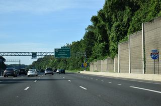 Mill Creek Park lines the west side of Interstate 495 beyond the sound walls by this reassurance marker.