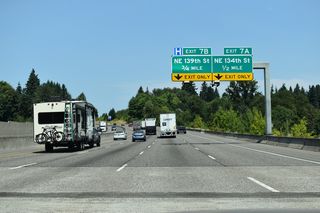 Interstate 5 crosses NE 117th Street and Salmon Creek at Salmon Creek Regional Park, 0.5 miles ahead of succeeding half diamond interchanges with NE 134th Street and NE 139th Street.