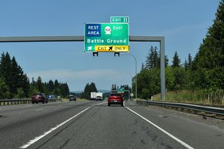 A distributor roadway separates at Exit 11 for both SR 502 (NE 219th Street) east and the Gee Creek Rest Area.