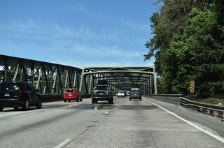 Just south of Woodland, a set of steel truss spans takes both directions of I-5 across the North Fork Lewis River. The southbound span was originally built in 1940. The northbound bridge was built in 1968 (WSDOT, 2025).