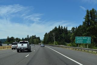 Castle Rock is 11.5 miles north of this distance sign. The Tacoma city center is 97 miles away.