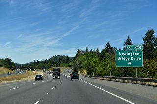Guide signs for Exit 42 previously referenced Ostrander Road and Pleasant Hill Roads, area roads that branch off adjacent Pacific Highway N (Old U.S. 99). Lexington Bridge Drive links I-5 with SR 411 (Westside Highway) between Beacon Hill and Sandy Bend.