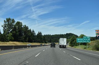 Interstate 5 north from the diamond interchange at Exit 52 was originally part of U.S. 99 (Pacific Highway). Paralleling I-5 to the west, Barnes Drive is pre-1950s alignment of U.S. 99. Toutle Park Road is a local road spurring east from adjacent Burma Road.