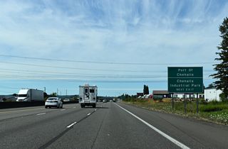 North beyond Exit 74, Interstate 5 reaches the twin cities of Chehalis and Centralia. As the freeway gets closer to the Puget Sound population belt, high-voltage power lines become an increasingly common sight.