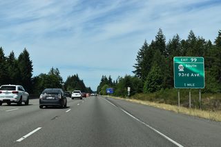 SR 121 returns to Interstate 5 at Exit 99 west along 93rd Avenue S. Several large distribution centers were built on previously rural land off SR 121 by 2023.