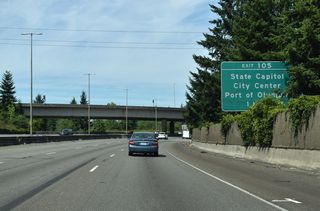 Curving east across Capitol Lake, Interstate 5 enters the city of Olympia ahead of Exit 105 to 14th Avenue SE and Henderson Boulevard.